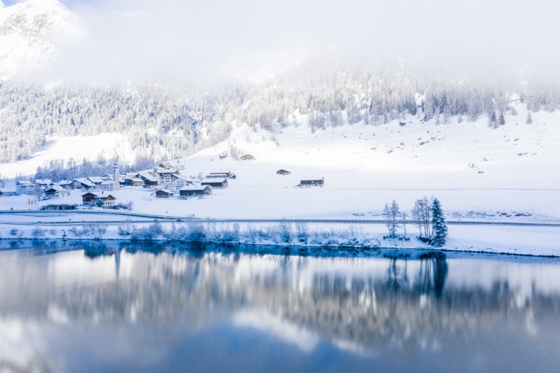 lake-by-snow-covered-hills-captured-foggy-day.jpg