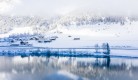 lake-by-snow-covered-hills-captured-foggy-day.jpg