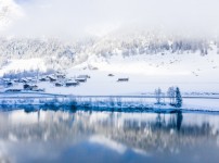 lake-by-snow-covered-hills-captured-foggy-day.jpg