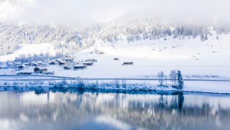 lake-by-snow-covered-hills-captured-foggy-day.jpg