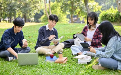 195461112-happy-young-asian-college-students-relaxing-in-the-campus-s-park-discussing-and-working-their-group.jpg