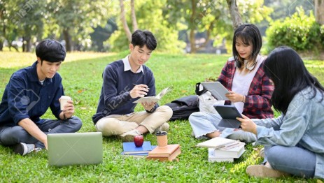 195461112-happy-young-asian-college-students-relaxing-in-the-campus-s-park-discussing-and-working-their-group.jpg