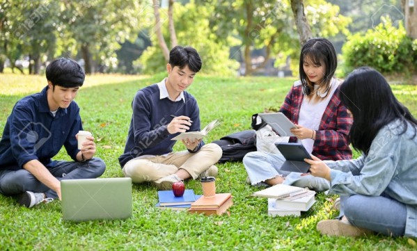 195461112-happy-young-asian-college-students-relaxing-in-the-campus-s-park-discussing-and-working-their-group.jpg